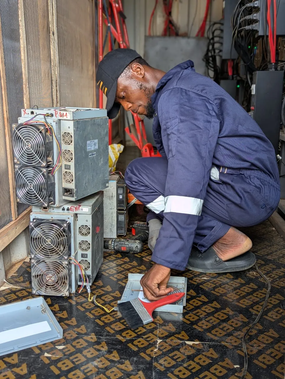 Our data technician working on ASIC miners inside out Bitcoin mining container